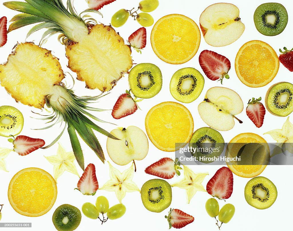 Sliced fruit on illuminated white surface, full frame
