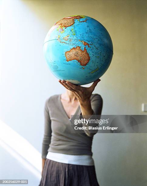 teenage girl (15-17) holding globe (focus on australia) - holding globe imagens e fotografias de stock