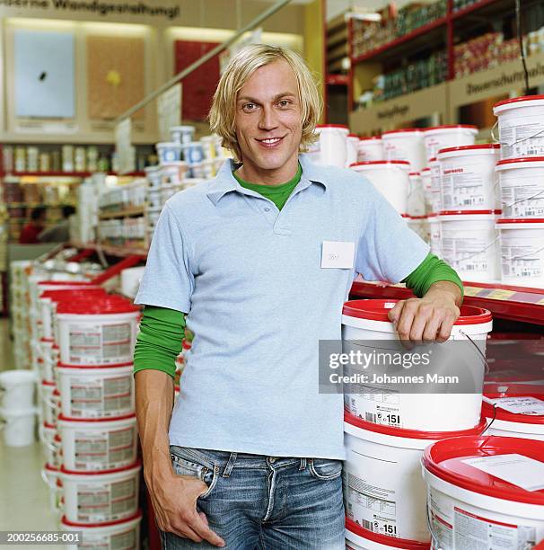 man leaning on buckets of liquid hardware shop, smiling, portrait - portrait mann business stock pictures, royalty-free photos & images
