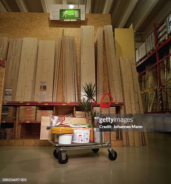 hardware goods on trolley by planks of wood - chariot photos et images de collection