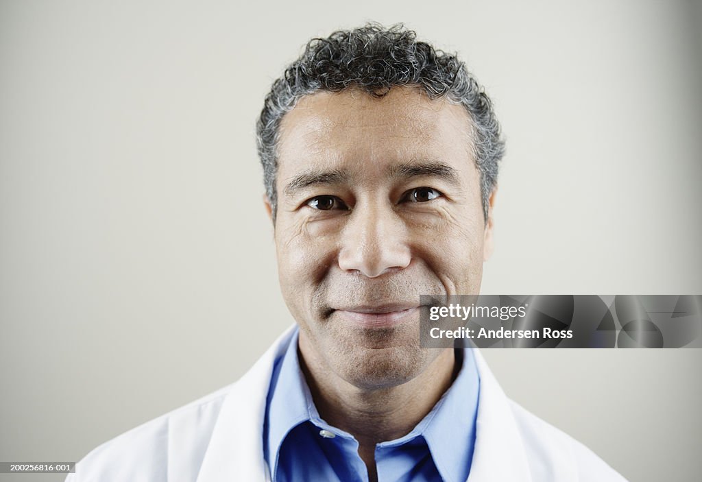 Mature male doctor smiling, portrait