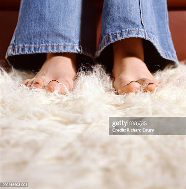 young woman with bare feet on furry carpet, low section, close-up - shag stock pictures, royalty-free photos & images