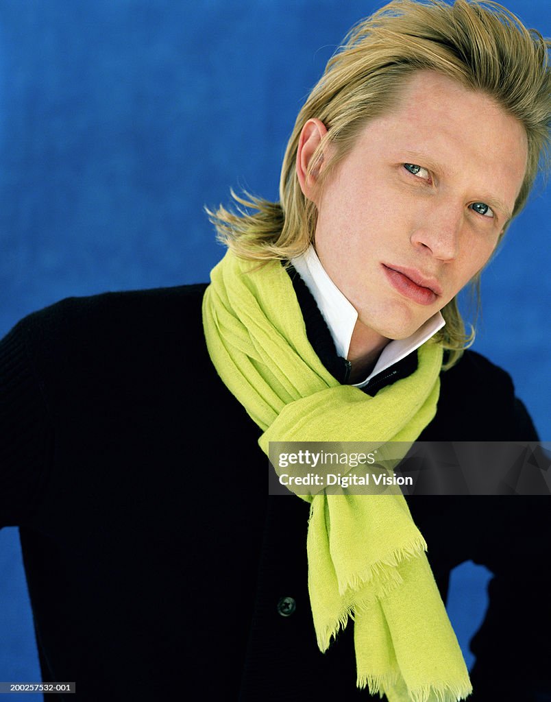 Young man wearing green scarf, portrait, close-up