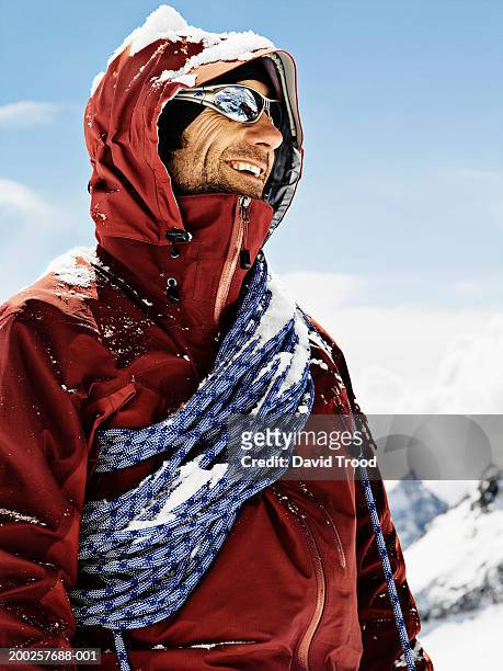 male mountain climber wearing sunglasses, smiling, close-up - hood clothing stock pictures, royalty-free photos & images
