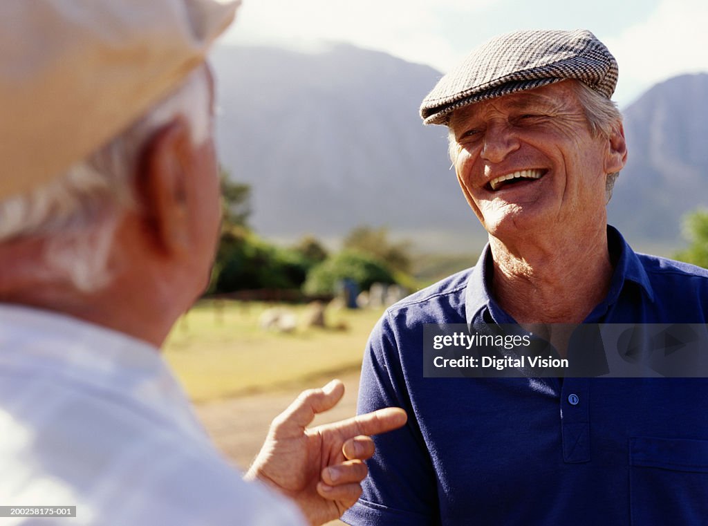 Two senior men outdoors, smiling