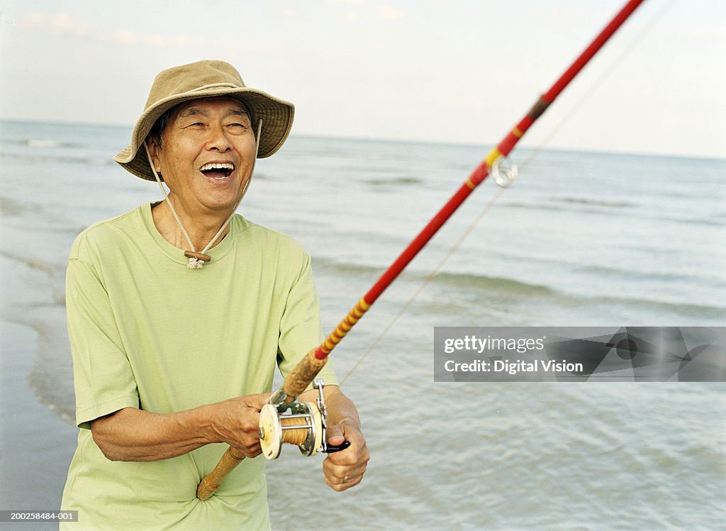 Senior Man Holding Fishing Rod Smiling Closeup High-Res Stock