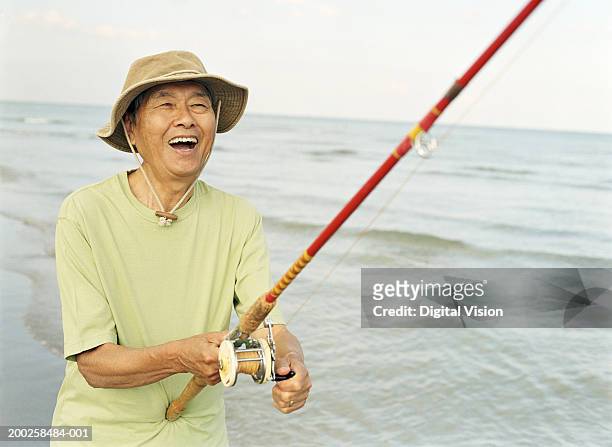 Senior Man Holding Fishing Rod Smiling Closeup High-Res Stock