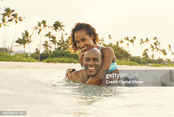 couple embracing in ocean, smiling, portrait - kailua stock-fotos und bilder