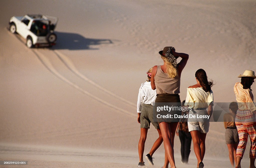 Group of people walking in desert