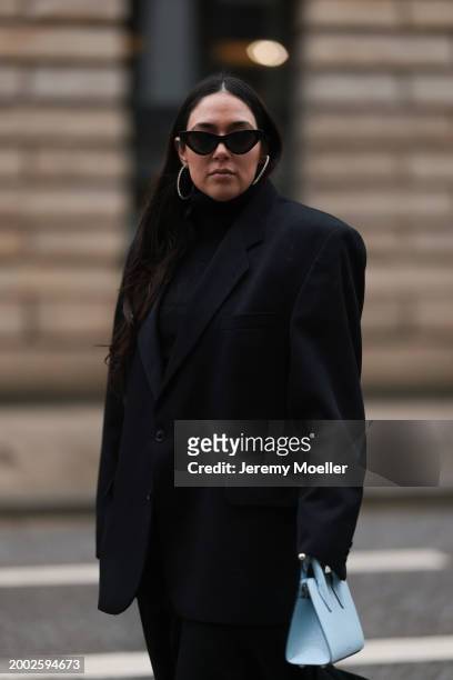 Jennifer Casimiro seen wearing black sunglasses, silver diamond earrings / hoops, Vintage black oversized blazer, COS black high neck cotton pleated...