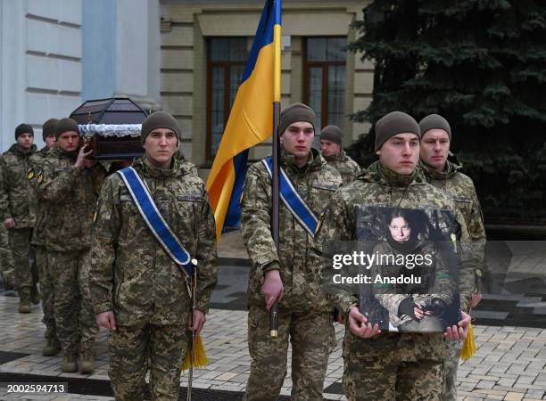 People attend a funeral ceremony of German female combat medic Diana Wagner in St. Michael's Golden-Domed Monastery in Kyiv, Ukraine, on February 14,...