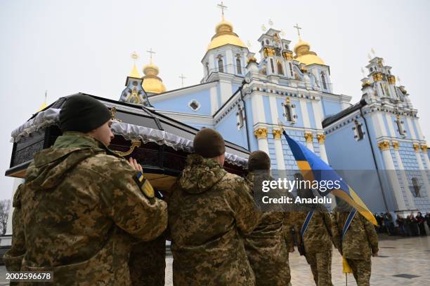 People attend a funeral ceremony of German female combat medic Diana Wagner in St. Michael's Golden-Domed Monastery in Kyiv, Ukraine, on February 14,...