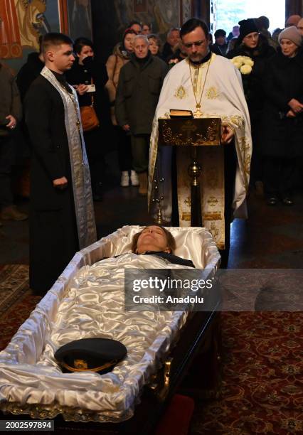 People attend a funeral ceremony of German female combat medic Diana Wagner in St. Michael's Golden-Domed Monastery in Kyiv, Ukraine, on February 14,...