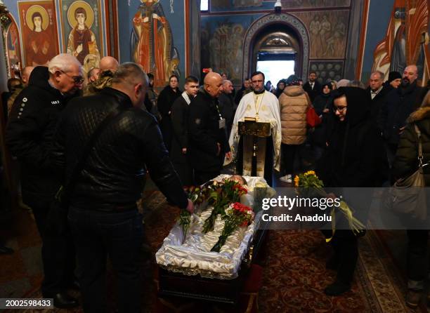 People attend a funeral ceremony of German female combat medic Diana Wagner in St. Michael's Golden-Domed Monastery in Kyiv, Ukraine, on February 14,...