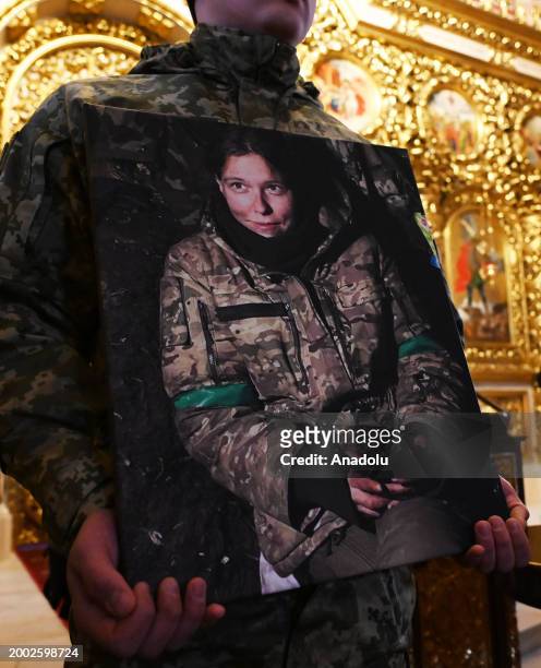 People attend a funeral ceremony of German female combat medic Diana Wagner in St. Michael's Golden-Domed Monastery in Kyiv, Ukraine, on February 14,...