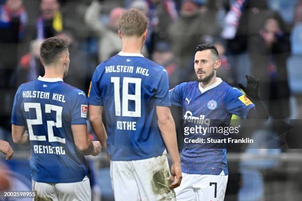 Steven Skrzybski of Holstein Kiel celebrates with teammates after scoring his team's first goal during the Second Bundesliga match between Holstein...