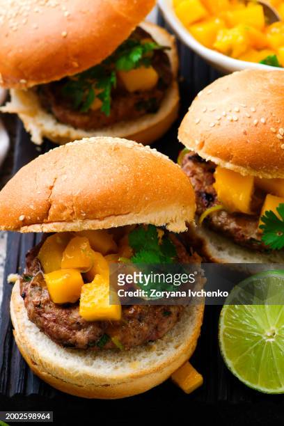 turkey burgers with mango salsa. - hen turkey stock pictures, royalty-free photos & images