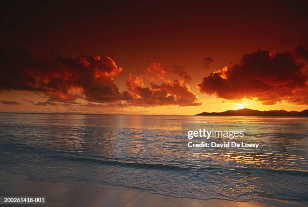 sunset at beach, view - overcast beach stock pictures, royalty-free photos & images