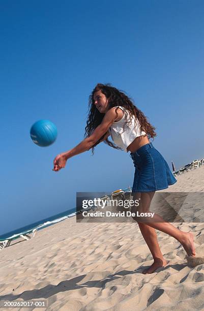 teenage girl (16-17) playing beach volleyball - girls beach volleyball stock pictures, royalty-free photos & images