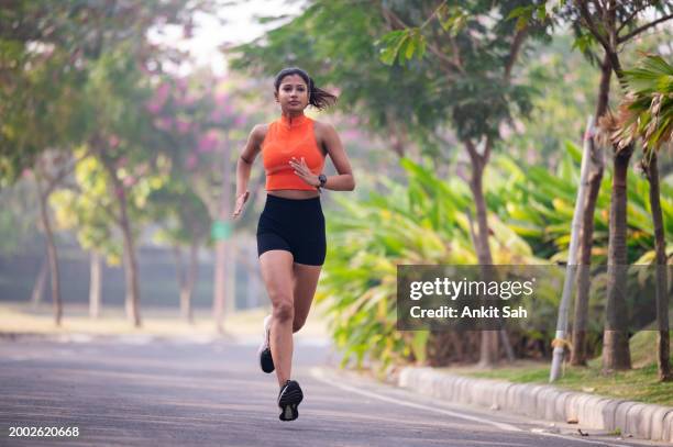 female runner in a park stock photo - women of india stock pictures, royalty-free photos & images