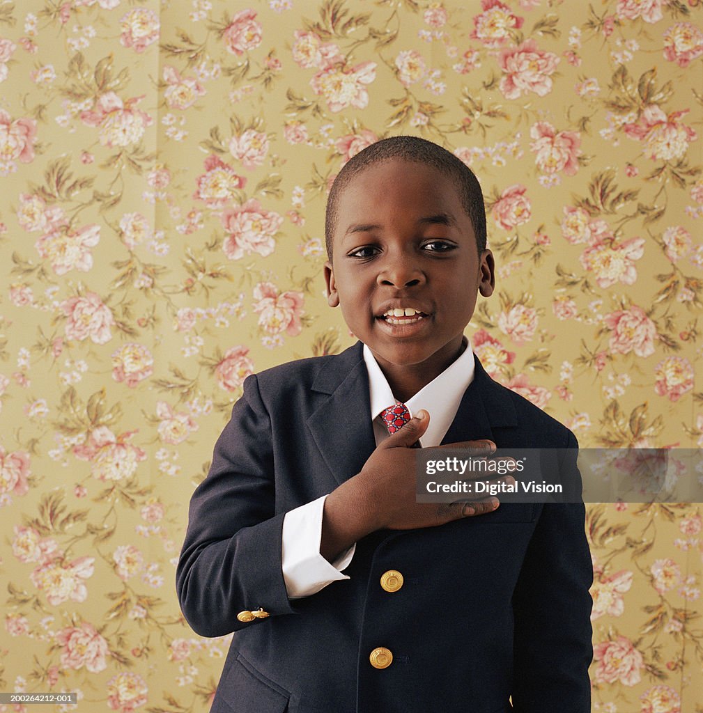 Boy (9-11) holding hand to chest, portrait