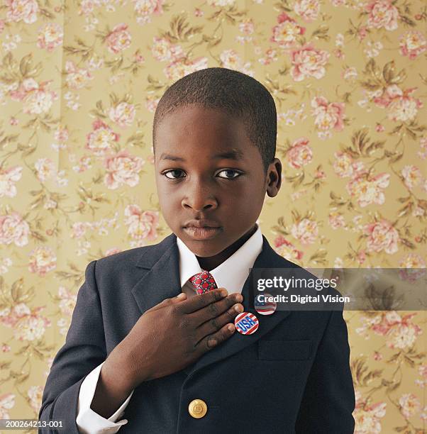 boy (9-11) holding hand to chest, portrait - golden boy stock pictures, royalty-free photos & images