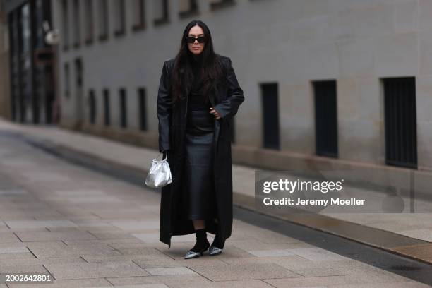 Jennifer Casimiro seen wearing Prada black Symbole sunglasses, Wolford black wool knit turtleneck pullover, Mango x Jen Ceballos black leather long...