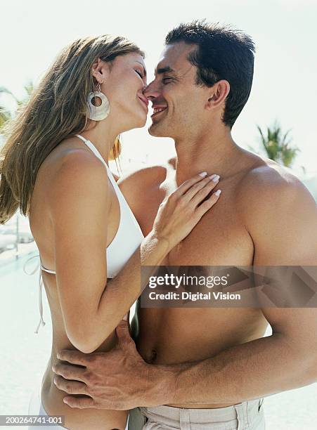 Couple Wearing Swimsuits Preparing To Kiss High-Res Stock Photo