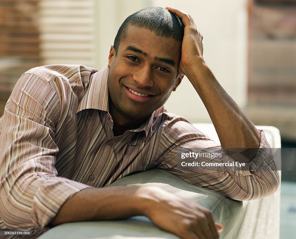 Man resting head on hand, portrait, close-up