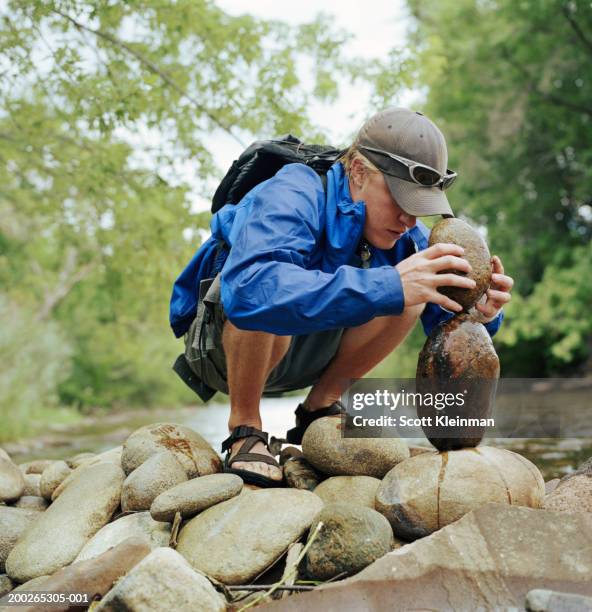 Man Stacking Rocks Photos and Premium High Res Pictures - Getty Images