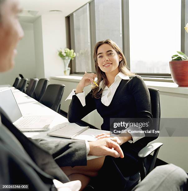 woman talking to colleague in conference room (focus on woman) - open discussion stock pictures, royalty-free photos & images