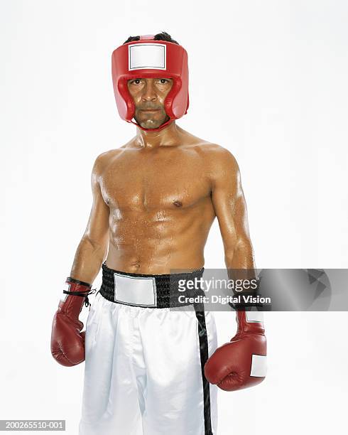 mature male boxer wearing head protection, portrait - pantaloncini da pugile foto e immagini stock