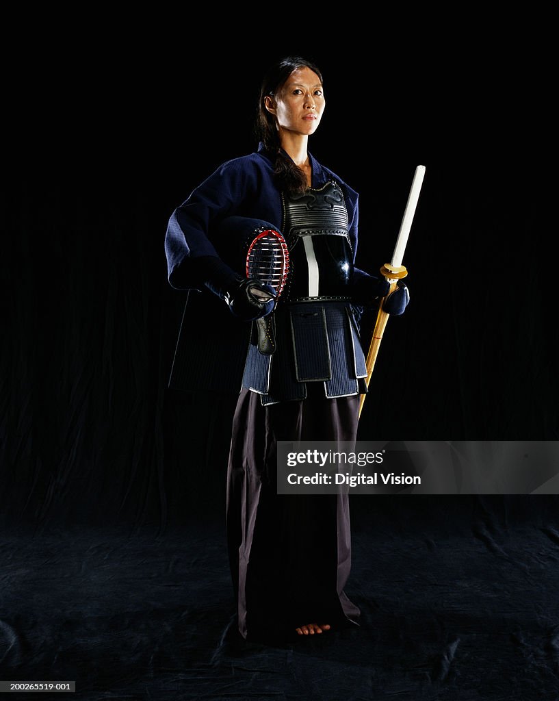 Woman wearing traditional Aikido costume, looking away