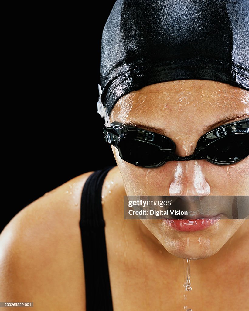 Female swimmer wearing cap and goggles, close-up