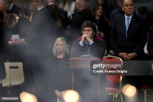 Argentina's President Javier Milei flanked by his sister Karina Elizabeth Milei and Argentina's Interior Minister Guillermo Francos attend a...