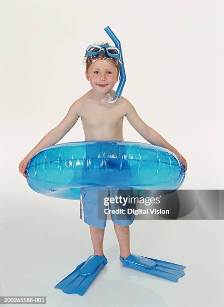 boy (4-6) standing in rubber ring wearing snorkelling gear, smiling - snorkel white background stock pictures, royalty-free photos & images