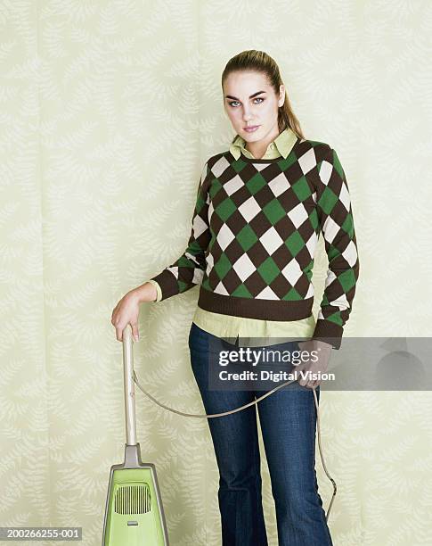 young woman standing with vacuum cleaner, portrait - kitsch bildbanksfoton och bilder