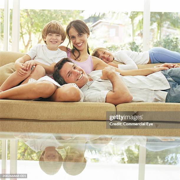 family relaxing in couch, portrait - lying on back girl on the sofa stock pictures, royalty-free photos & images