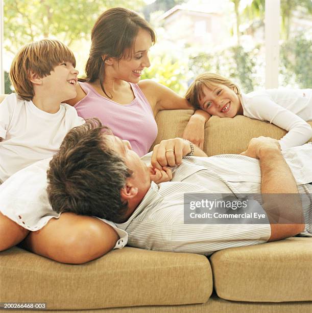 family laughing on couch, close up - lying on back girl on the sofa stock pictures, royalty-free photos & images