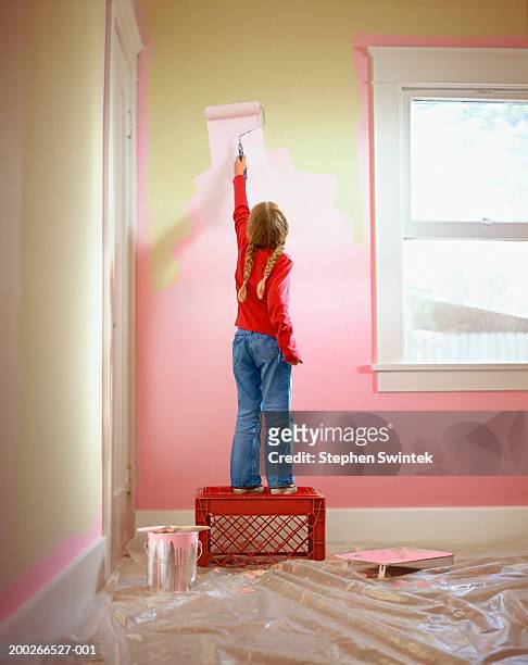 girl (4-6) helping to paint bedroom, rear view - children room wall stock pictures, royalty-free photos & images