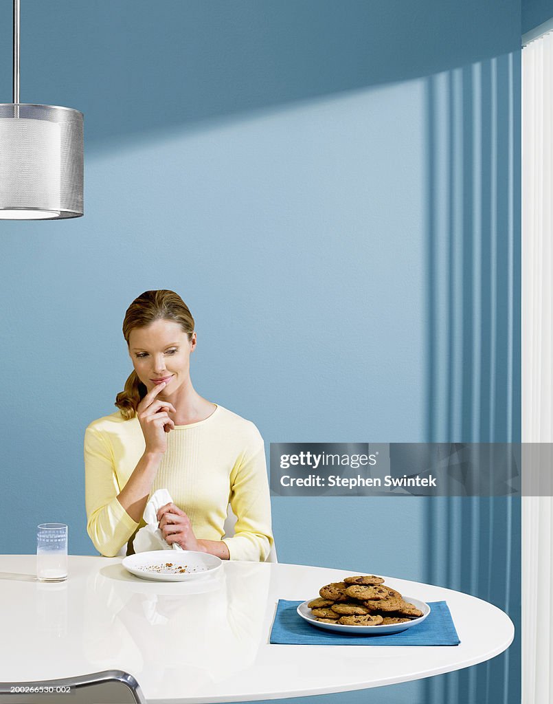 Woman looking at plate of cookies