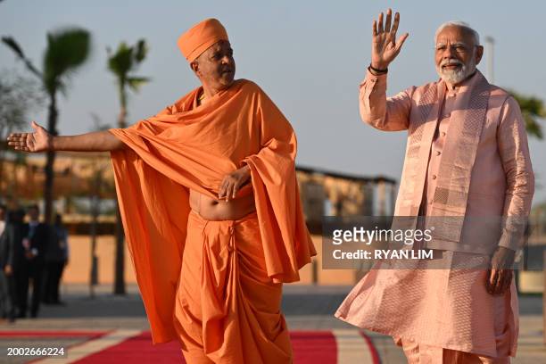 India's Prime Minister Narendra Modi waves during a tour of the BAPS Hindu Mandir, the largest Hindu temple in the Middle East, at its inauguration...