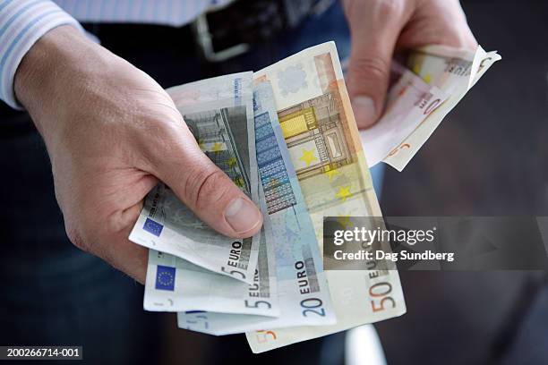 man holding euro currency: various denomination notes - twenty euro note 個照片及圖片檔