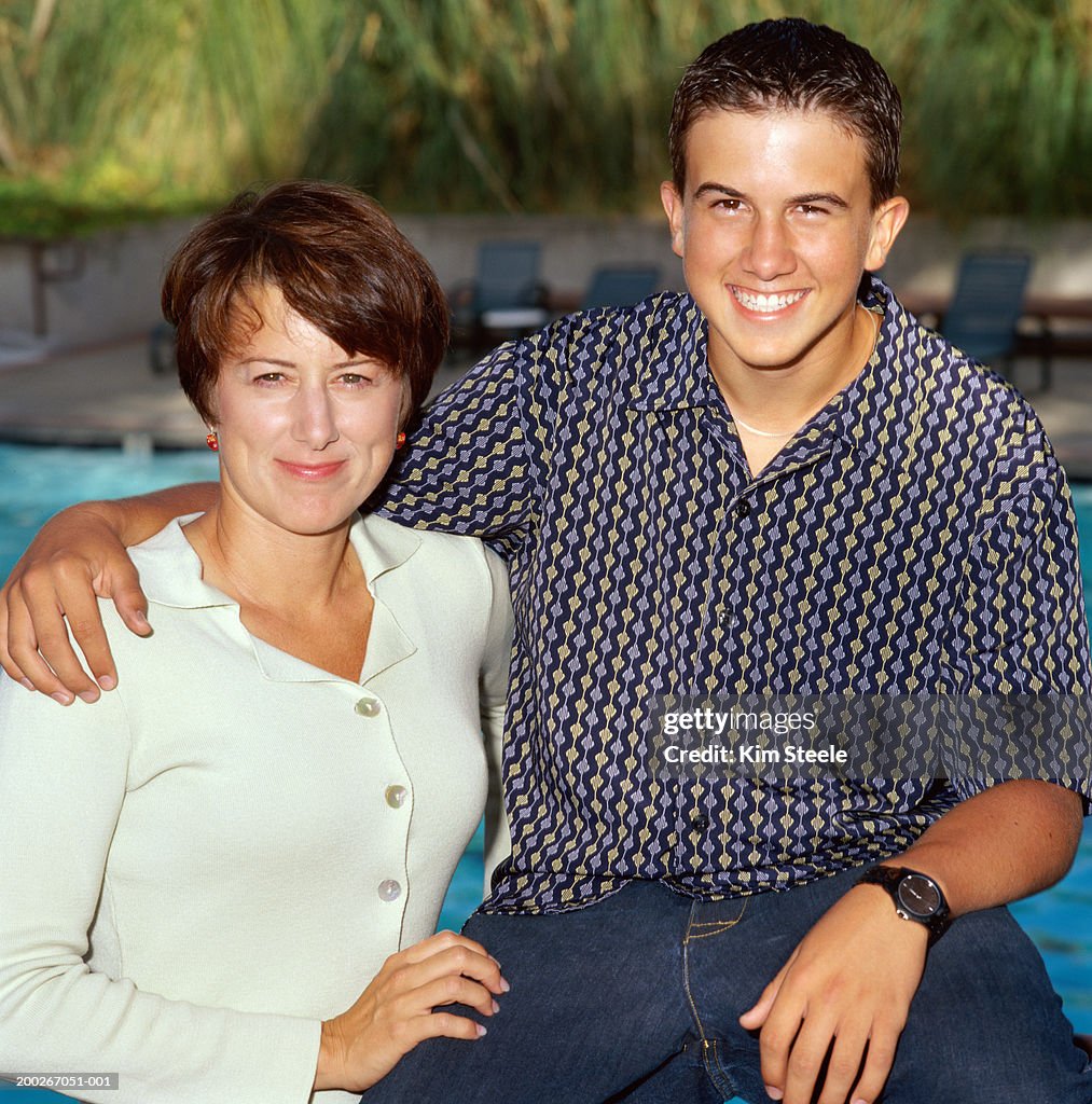 Mother and teenage son (15-17) embracing, smiling, close-up, portrait