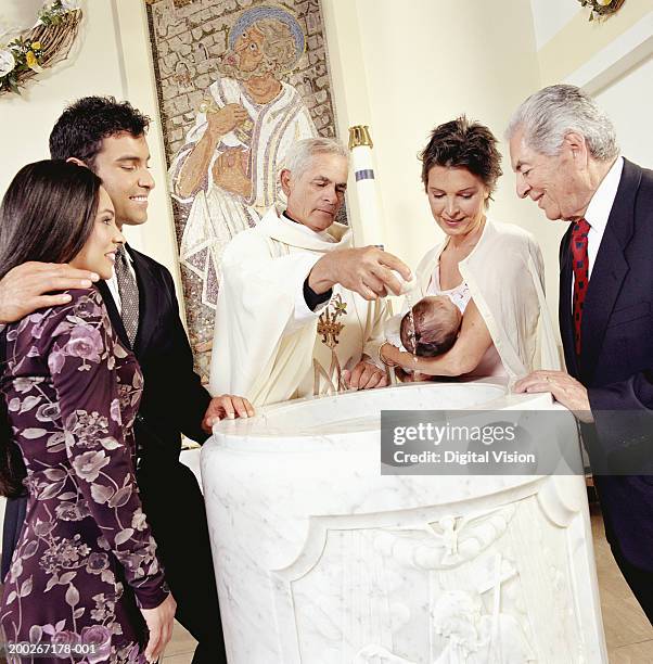 baby boy (0-3 months) being baptised - baptism stock pictures, royalty-free photos & images