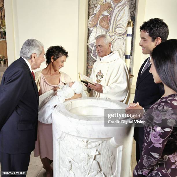 baby boy (0-3 months) being baptised - dopen stockfoto's en -beelden