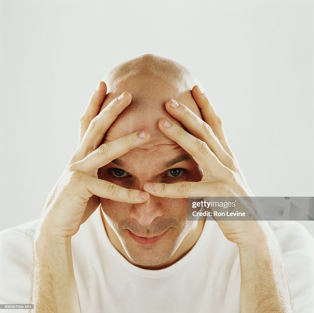 Man with hands on head and face, portrait