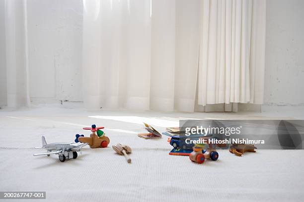 children's toys on floor in living room - juguetes fotografías e imágenes de stock
