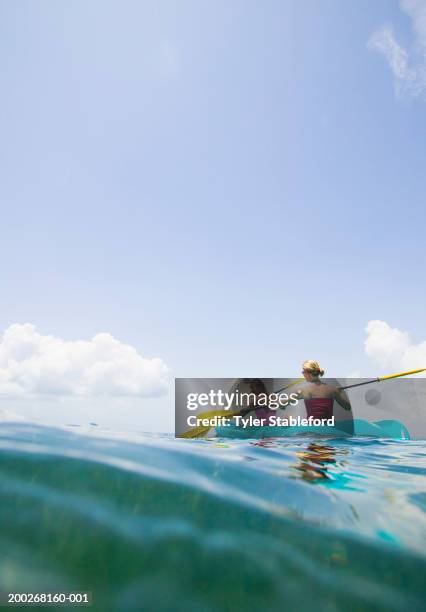 two young women sea kayaking - mid distance stock pictures, royalty-free photos & images