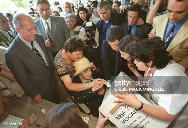 Ema Escobar, 103 years and the mother of Ricardo Lagos , deposits her voting ballot at the national stadium in Santiago 12 December 1999. Ema Escobar...